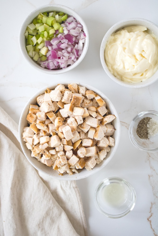 Chicken salad sandwich ingredients on a table.