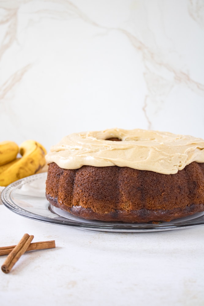 Frosted banana cake on a plate.