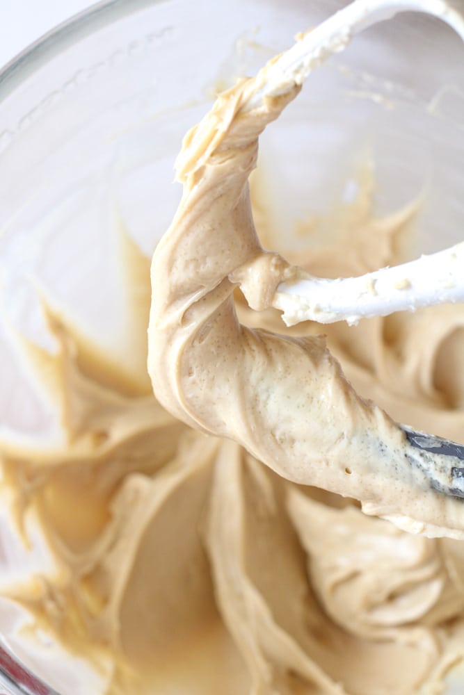 Whipped brown sugar frosting on a stand mixer paddle attachment.