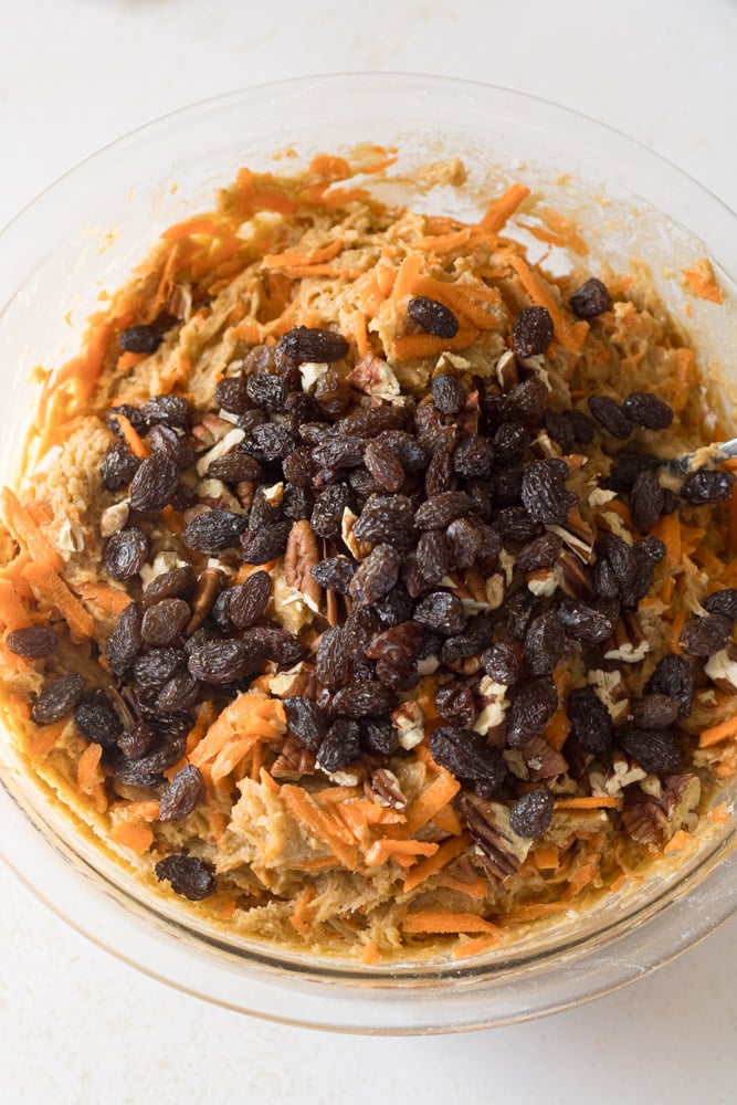 Carrot muffins with shredded carrots, chopped nuts, and raisins.