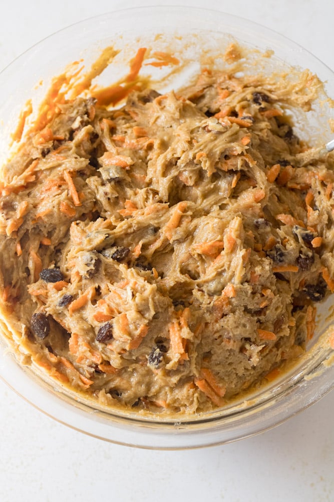 Mixed carrot cake muffins batter in a bowl.