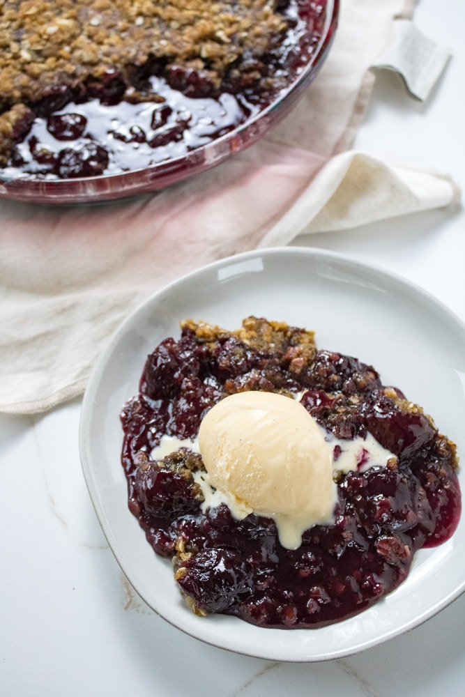 Cherry crisp with a scoop of ice cream on top.