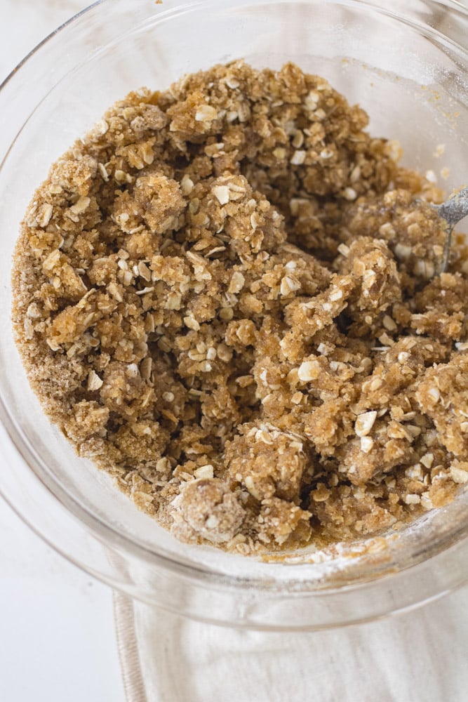 Mixed oat topping in a bowl with melted butter.