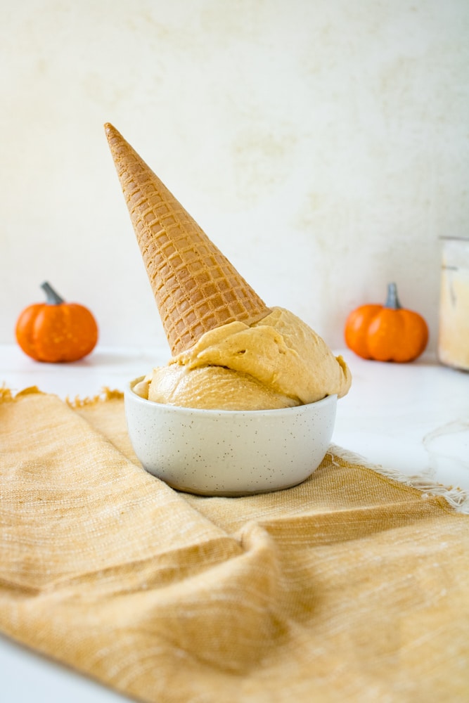 Ninja Creami pumpkin pie ice cream in a bowl with a cone on top.