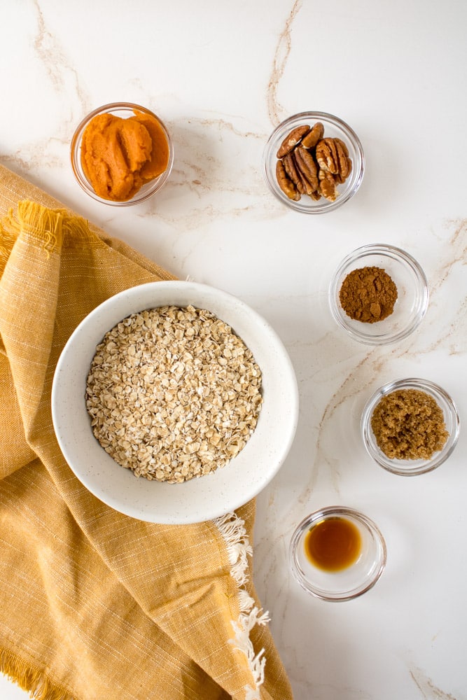 Overhead image of pumpkin oatmeal ingredients on a table. 