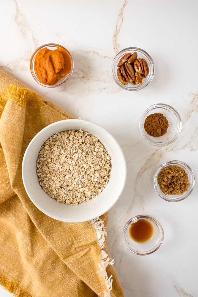 Overhead image of pumpkin oatmeal ingredients on a table.