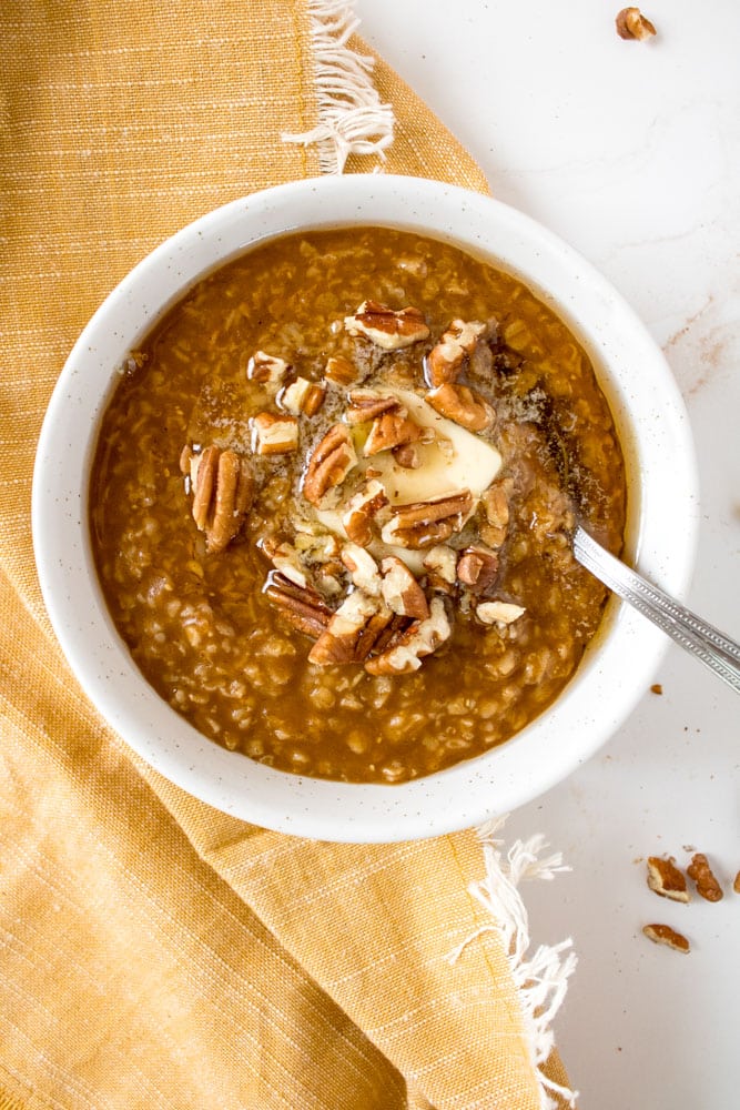 Pumpkin oatmeal with butter and toppings.