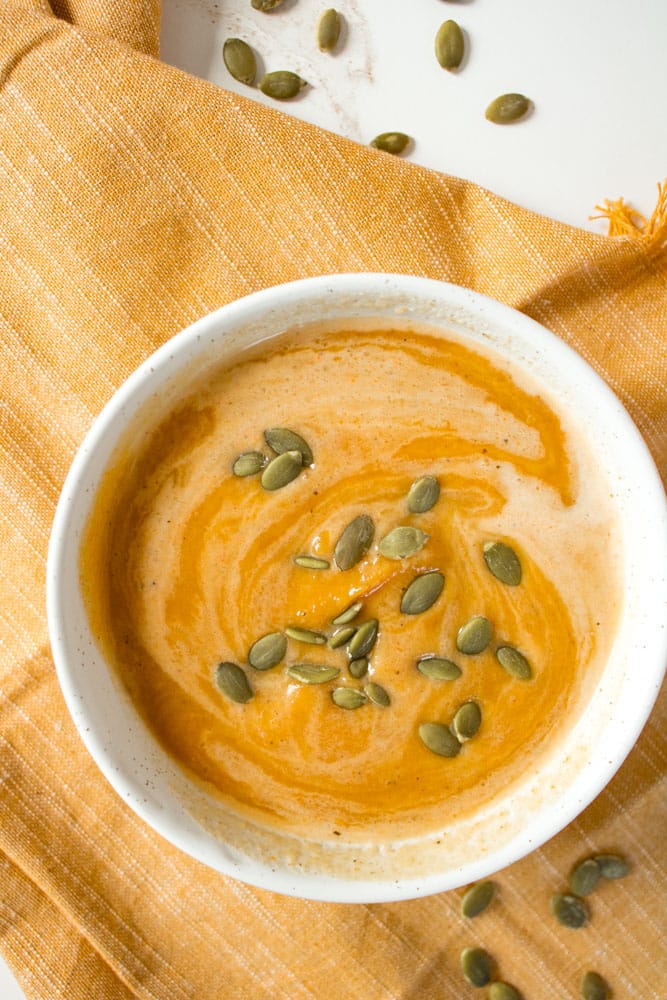 Butternut squash soup with cream and pumpkin seeds.