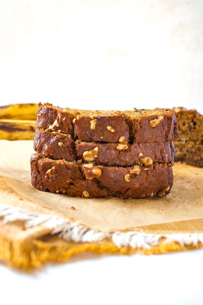 Side view of a stack of sliced banana bread.