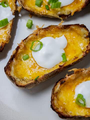 Close up image of potato skins with cheese.
