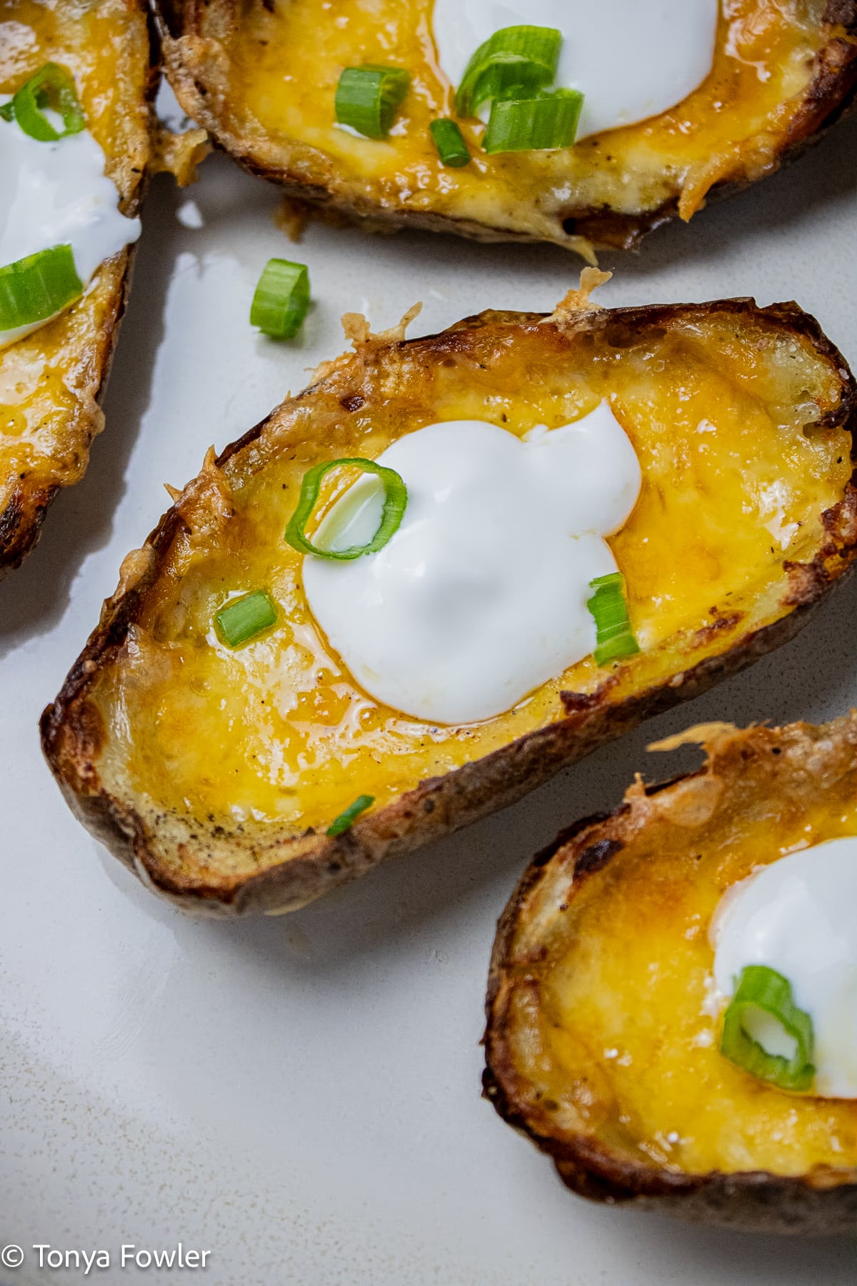 Close up image of potato skins with cheese.