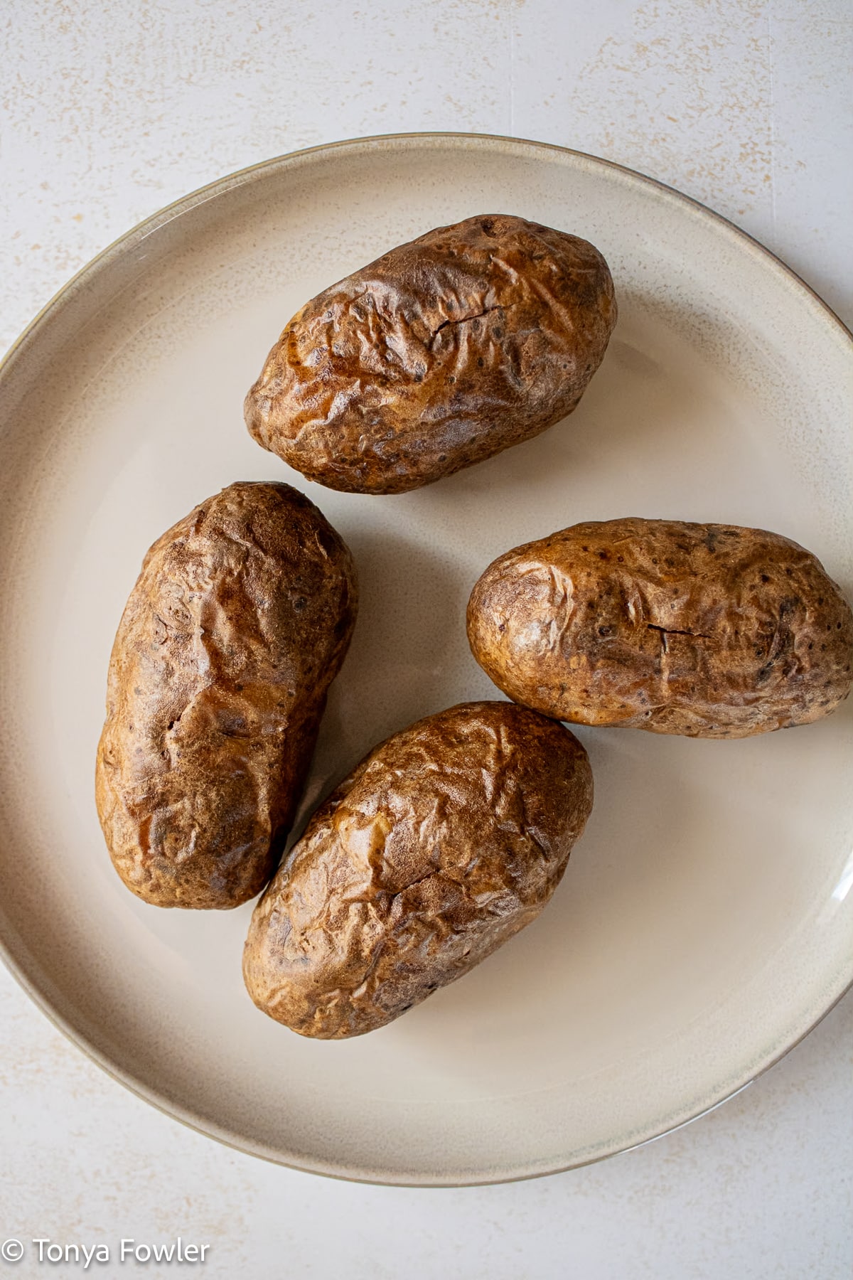 Baked potatoes on a plate.