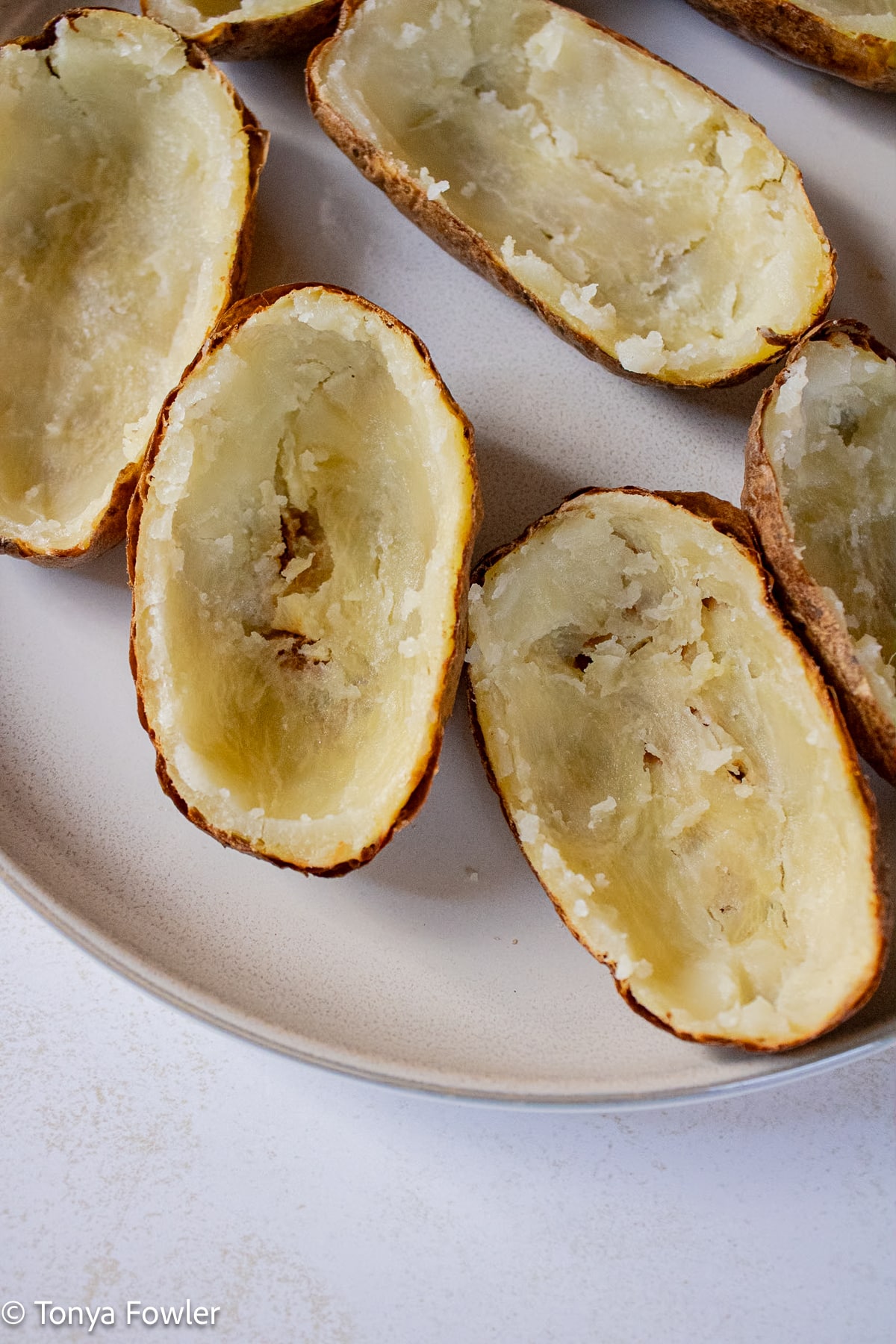 Baked potatoes with the insides scooped out. 