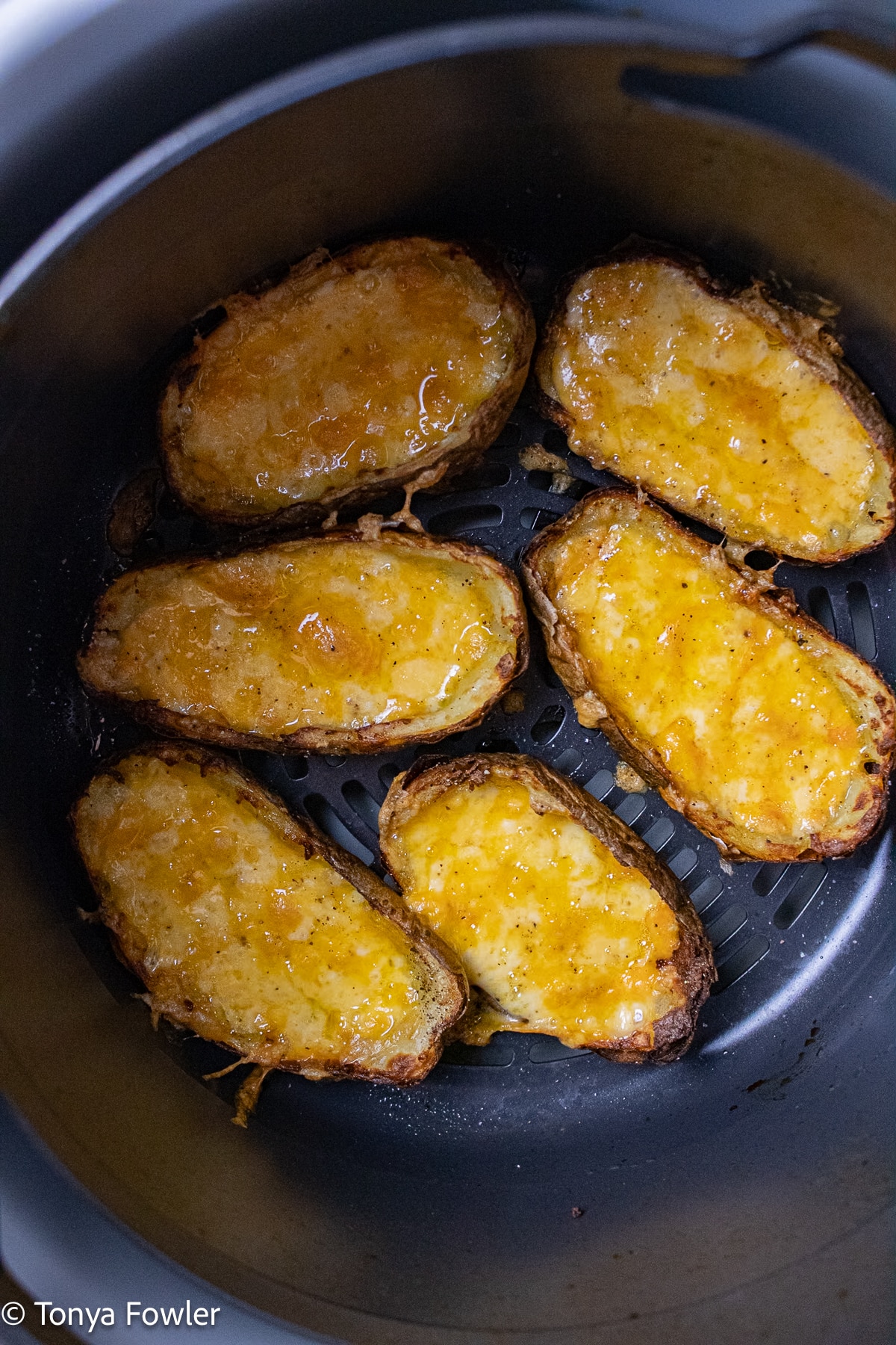 Potato skins with cheese inside in the air fryer.
