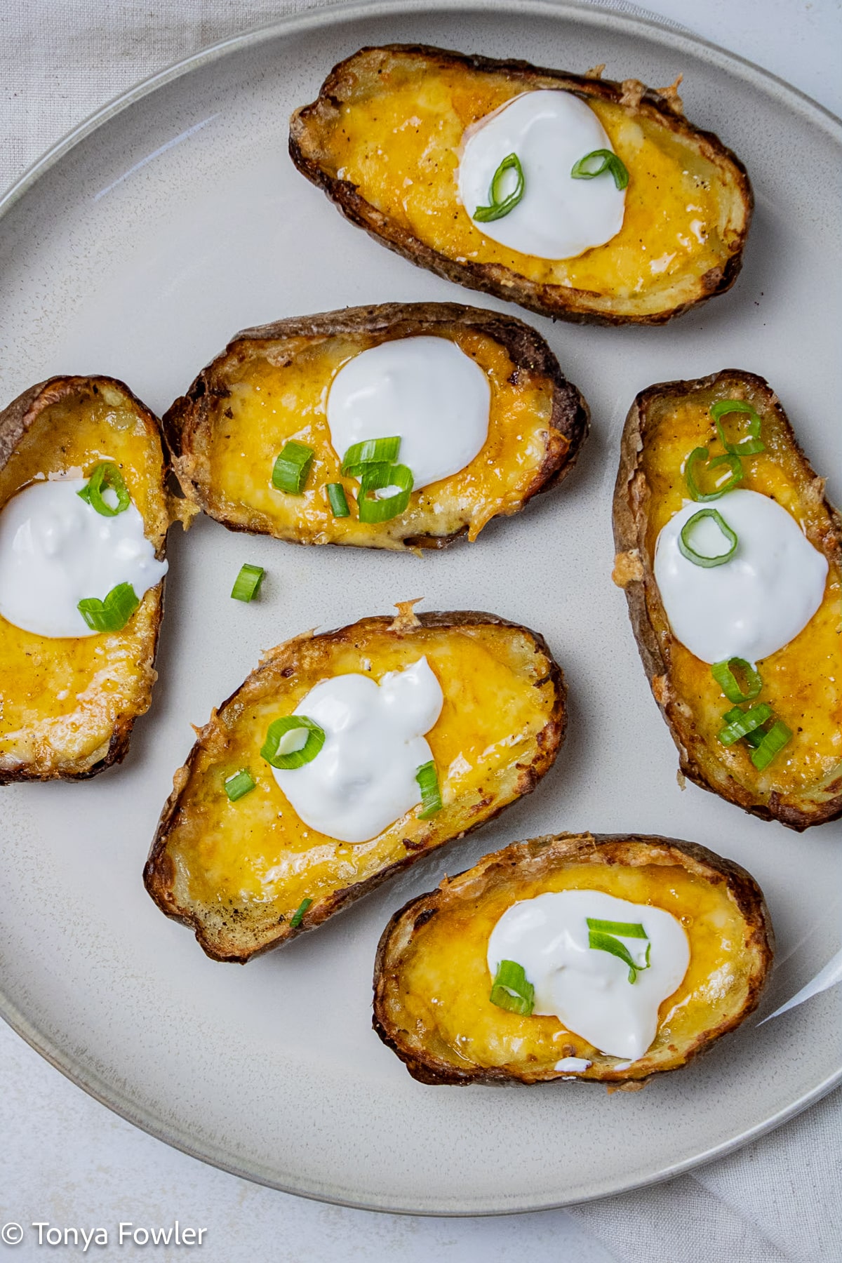 Overhead image of potato skins with cheese.
