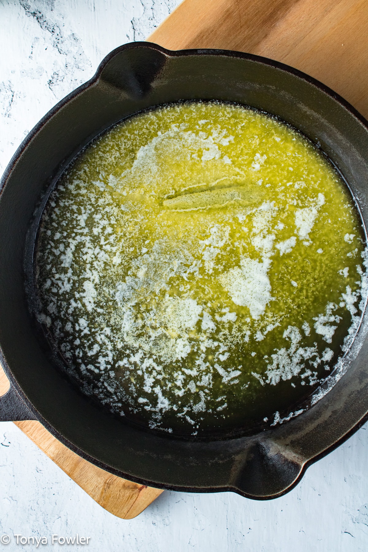 Melted butter in a cast iron skillet.