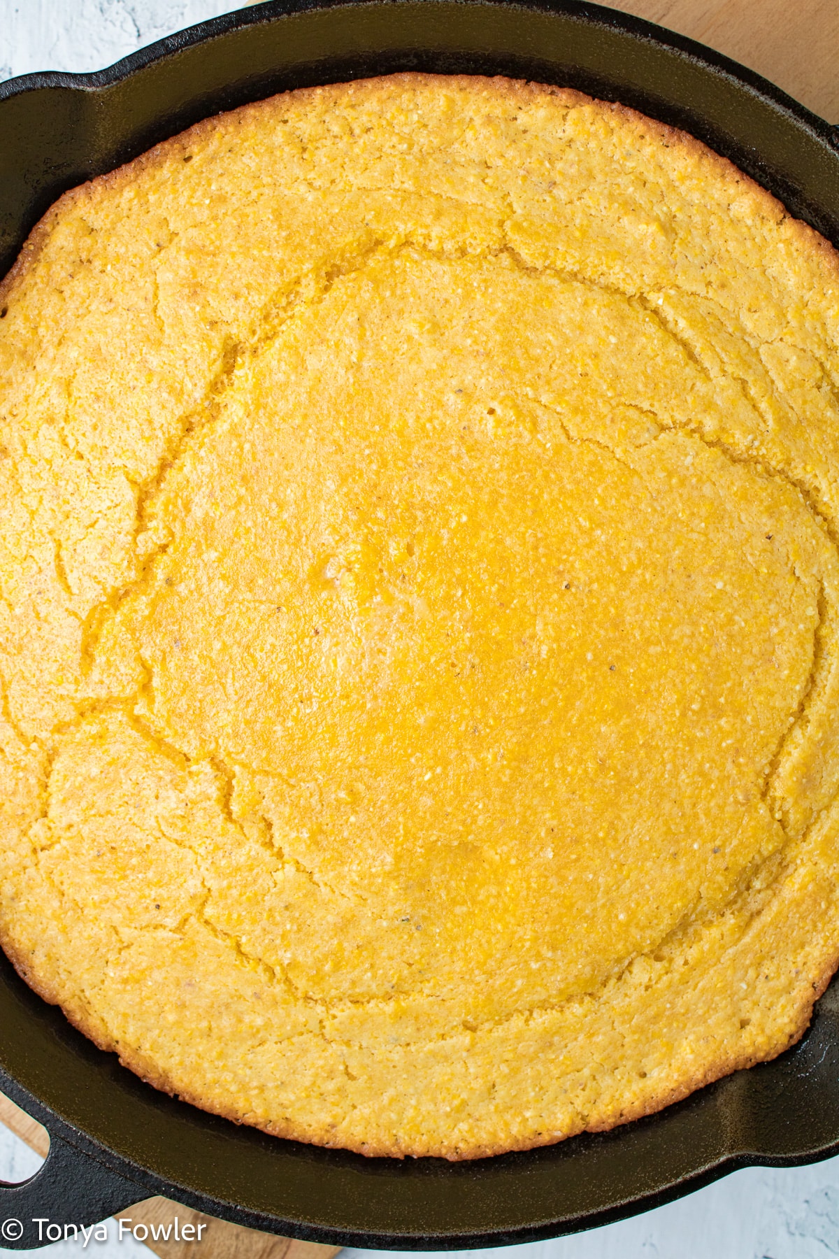 Close up image of cornbread in a skillet.