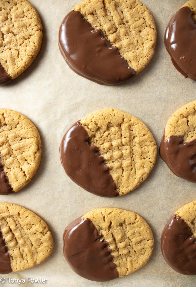Chocolate dipped cookies on a sheet pan.