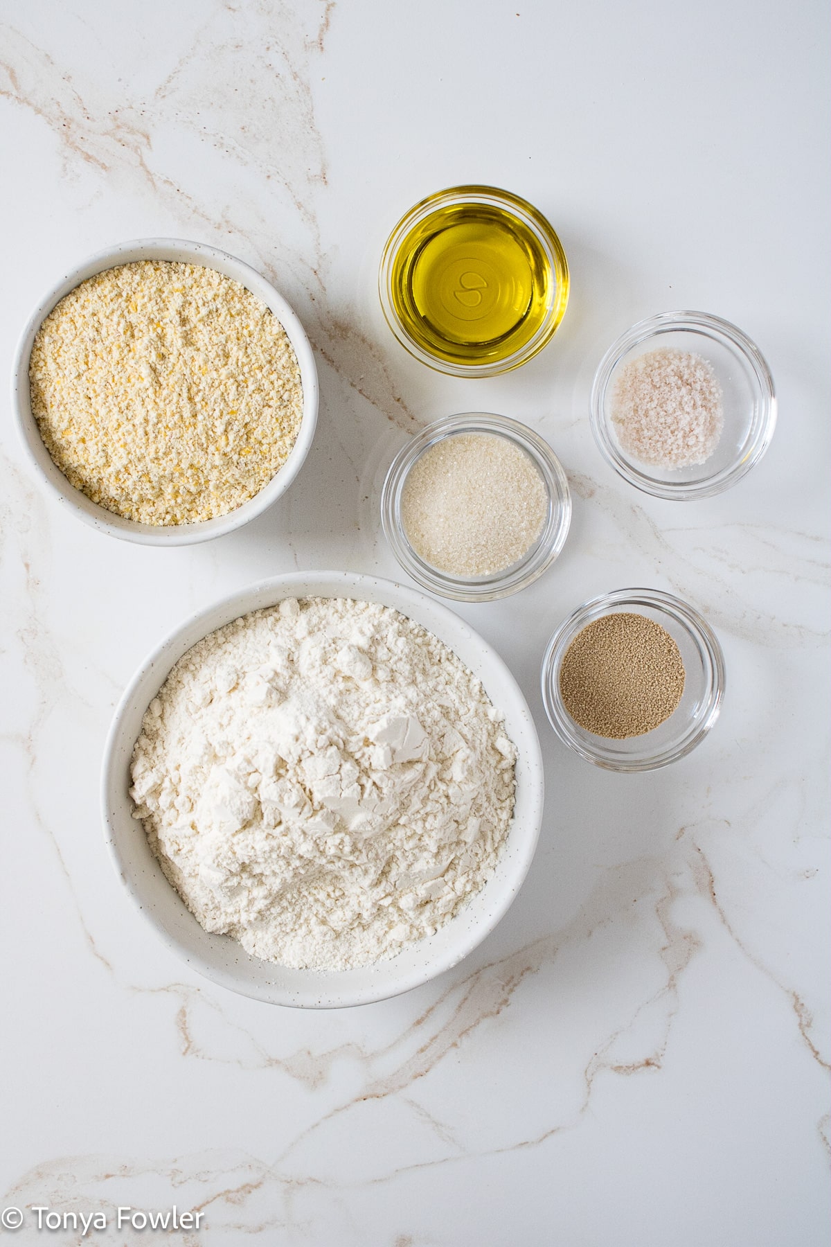 Cornmeal pizza crust ingredients on a table.