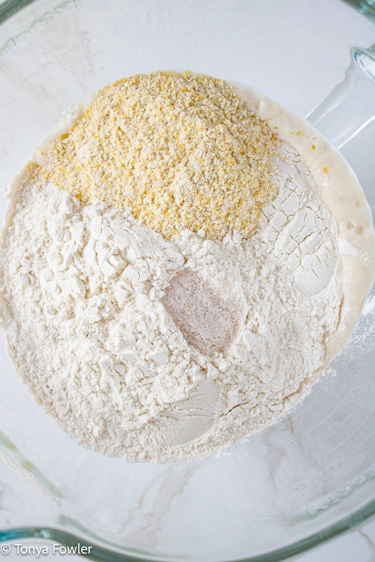 Pizza crust ingredients in a stand mixer.