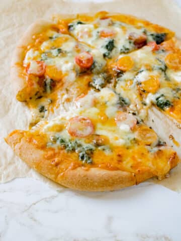 Spinach goat cheese pizza on cornmeal crust.