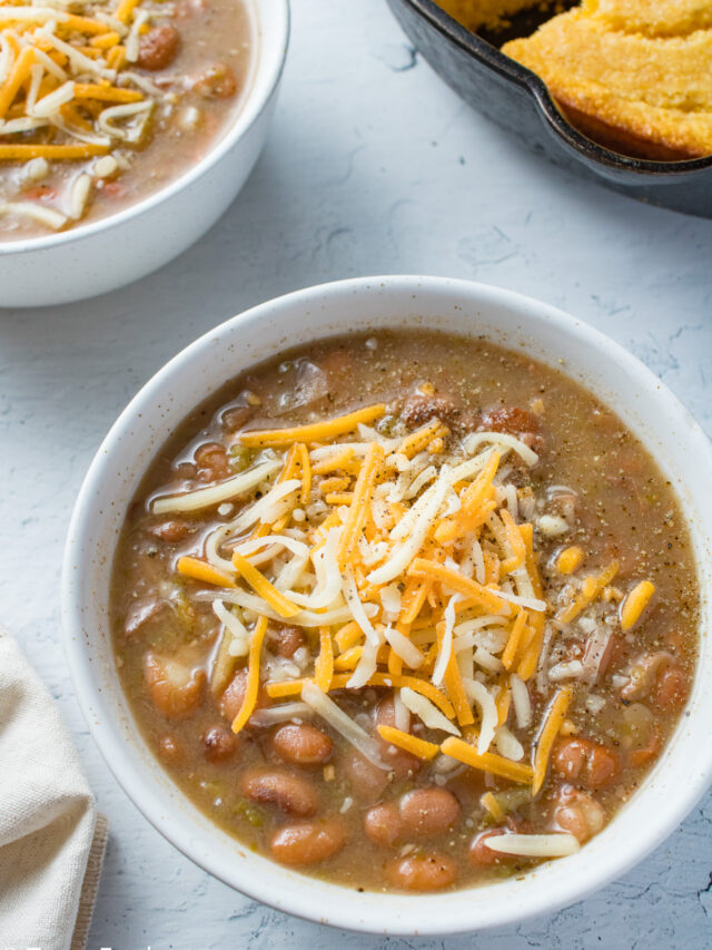 Beans in a bowl with cheese on top.