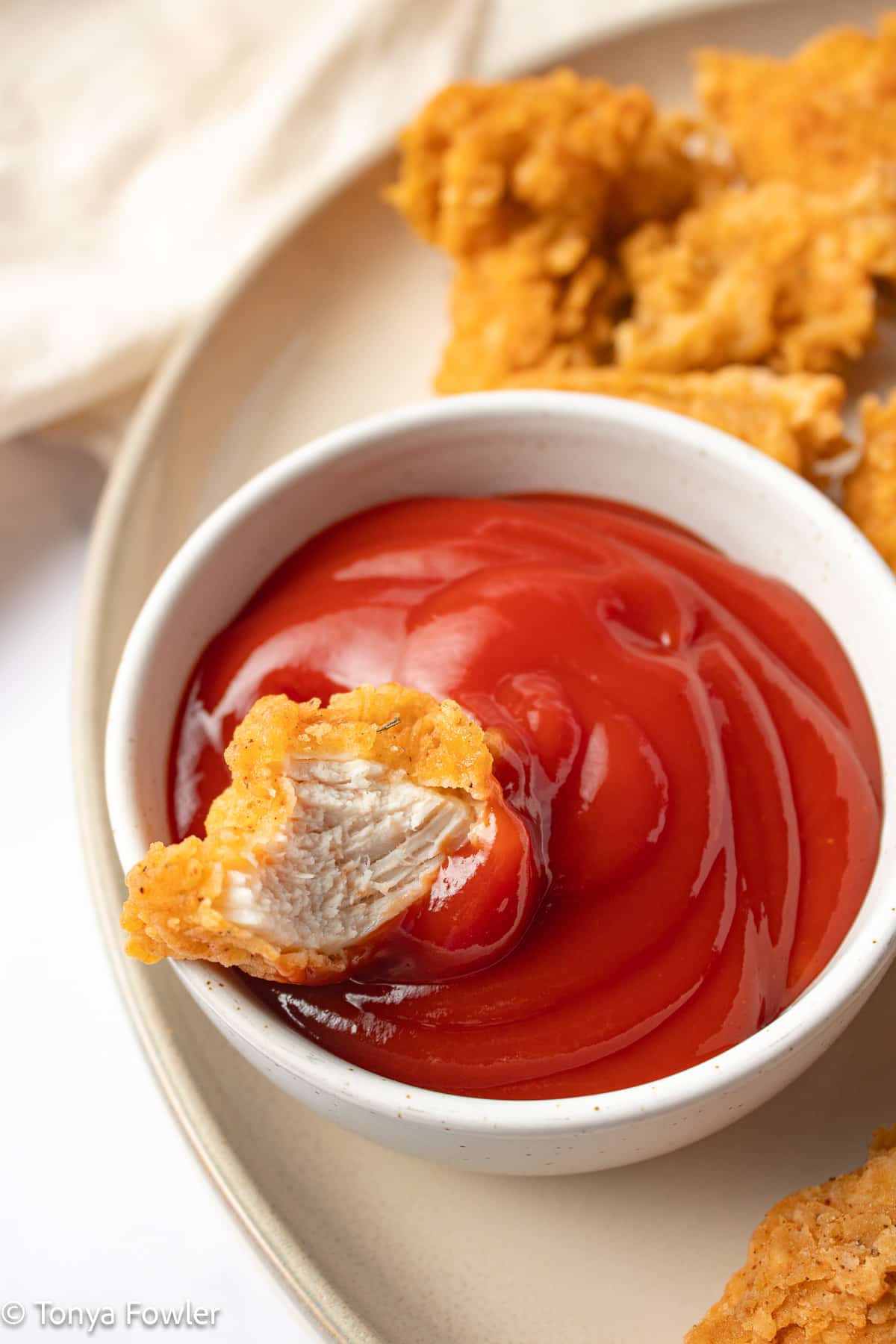 Chicken nugget in ketchup.