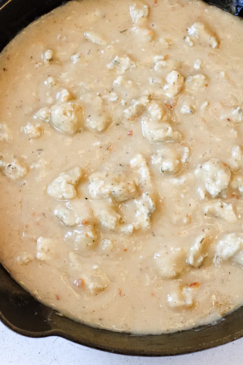Overhead image of chicken sausage gravy in a cast iron skillet.