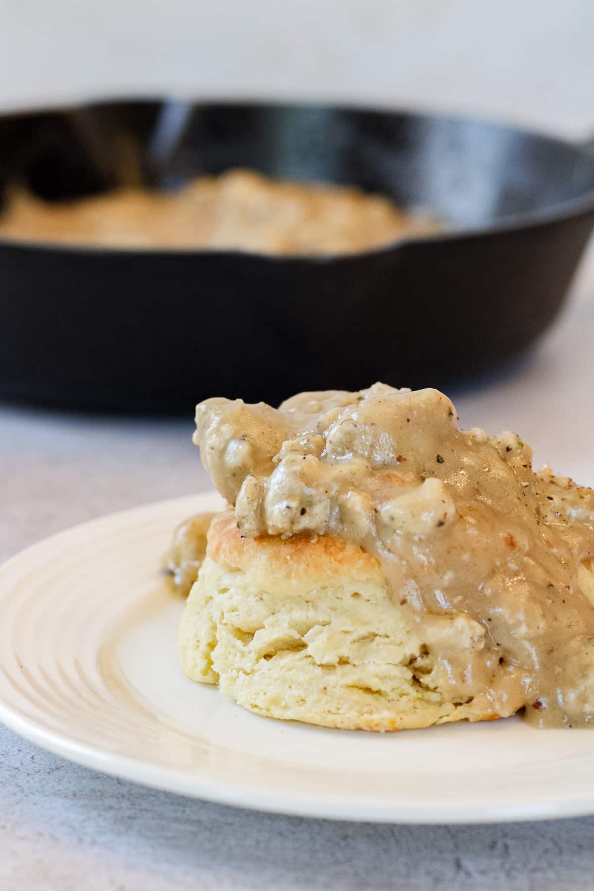 Side image of chicken sausage gravy on a biscuit.