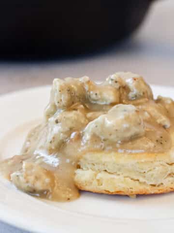 Close up image of chicken sausage gravy on a biscuit.