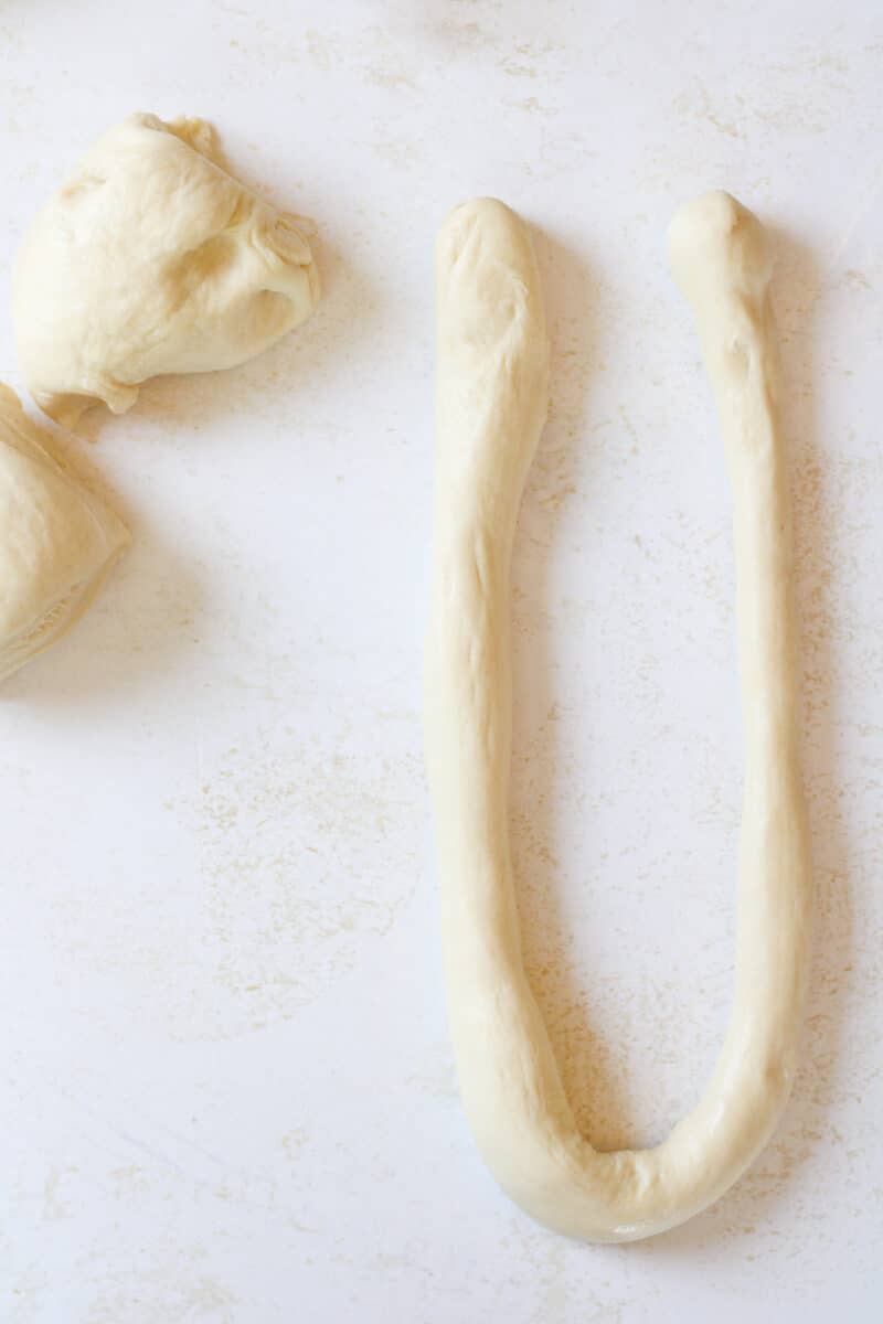 Pretzel dough on a counter in the shape of a "U".