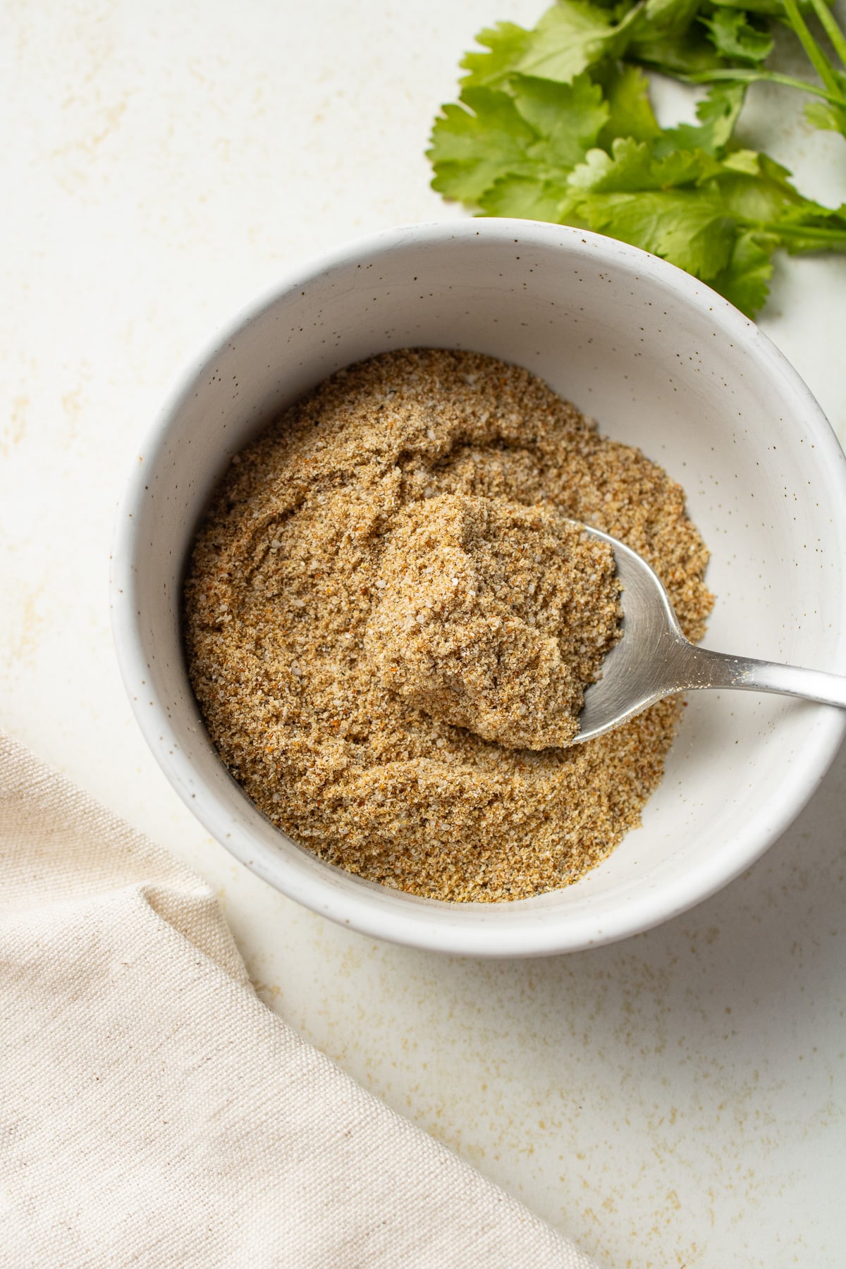 Seasonings in a bowl with a spoon. 