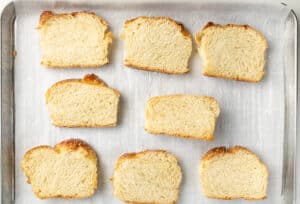 Sandwich bread slices on a sheet pan.