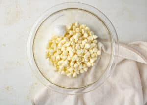 White chocolate chips in a bowl with coconut oil.