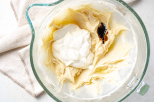 Sour cream cheesecake ingredients in the bowl of a stand mixer.