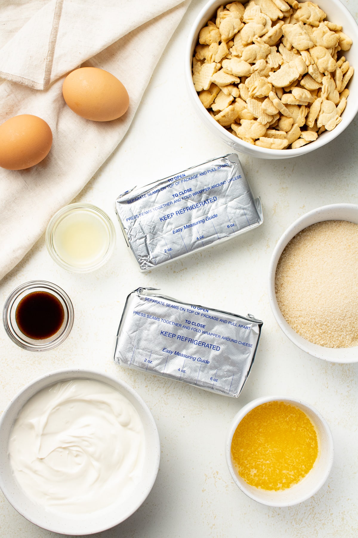 Overhead image of cheesecake ingredients on a table.