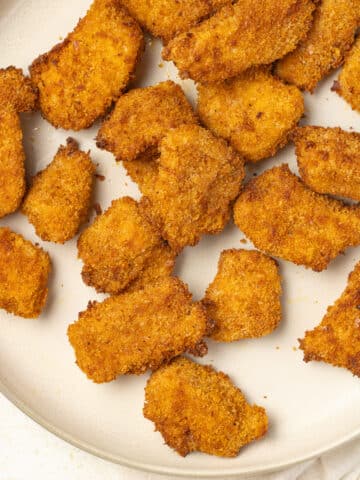 Air fryer chicken nuggets on a plate.