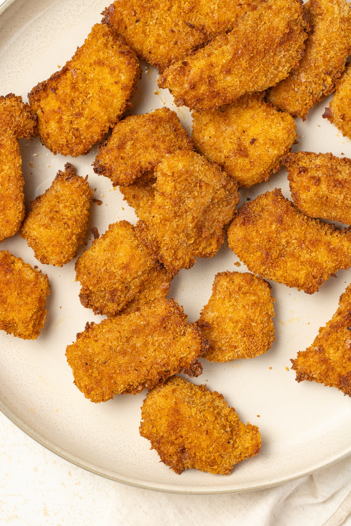 Air fryer chicken nuggets on a plate.