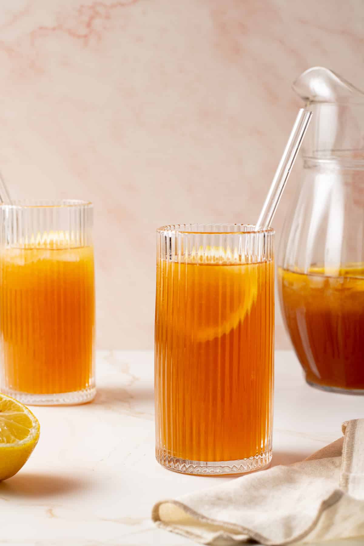 Iced tea in glasses with lemon slices.