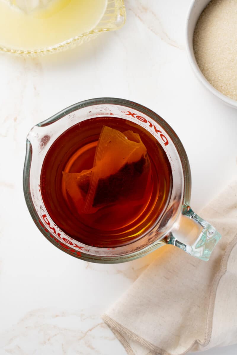 Tea steeping in a measuring cup.