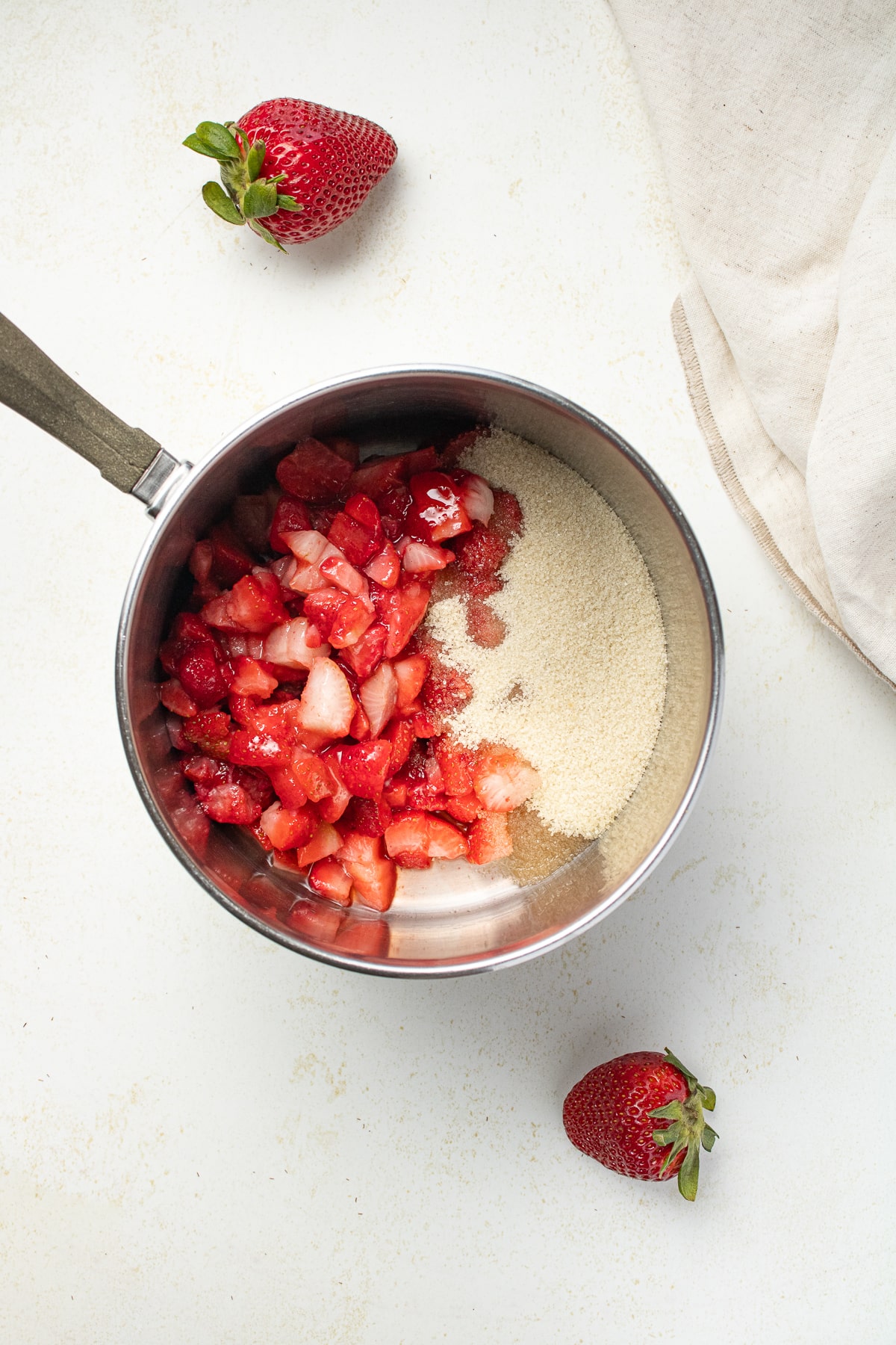 Strawberry sauce ingredients a pot.