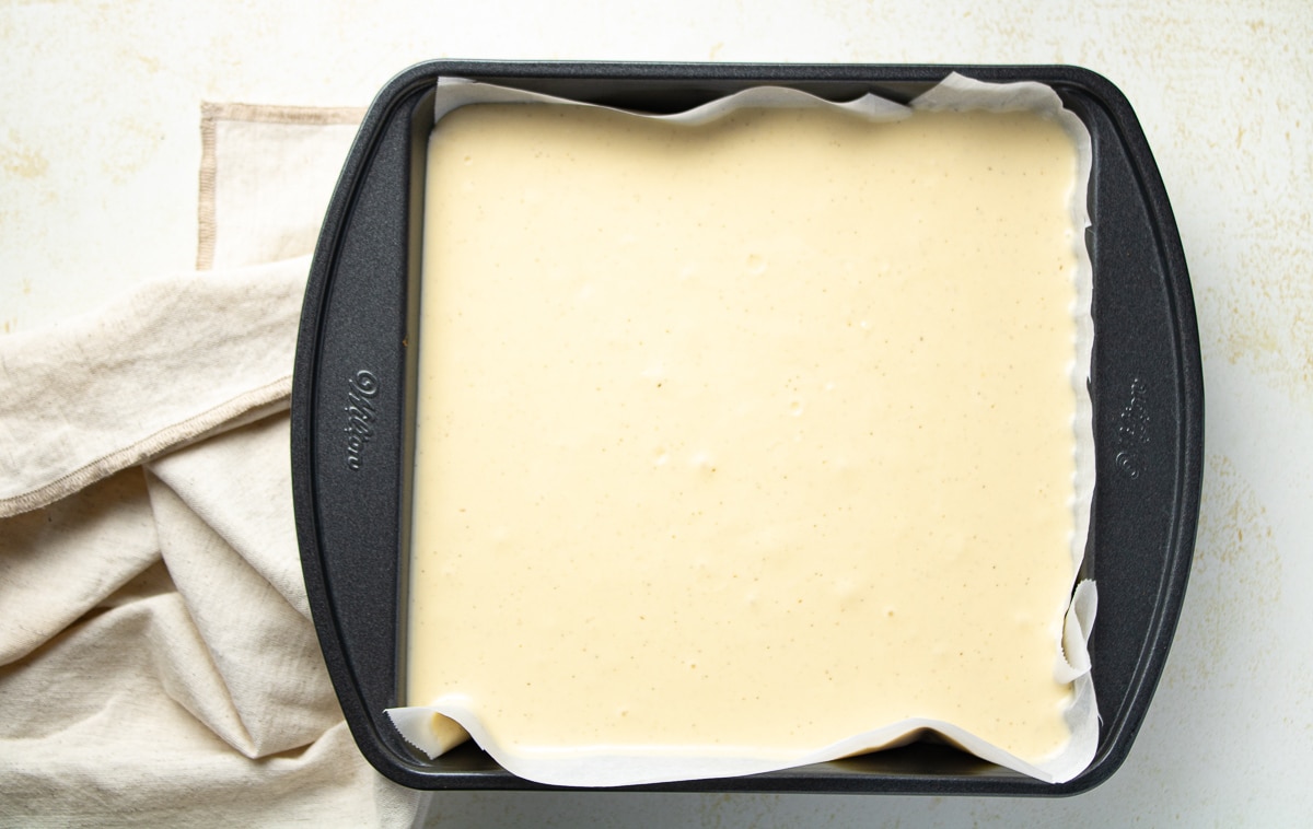 Cheesecake filling in a cake pan.