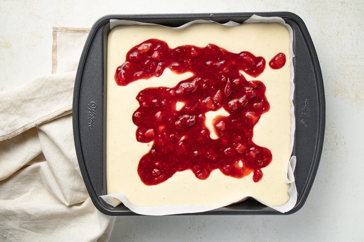 Cheesecake filling topped with strawberry sauce.