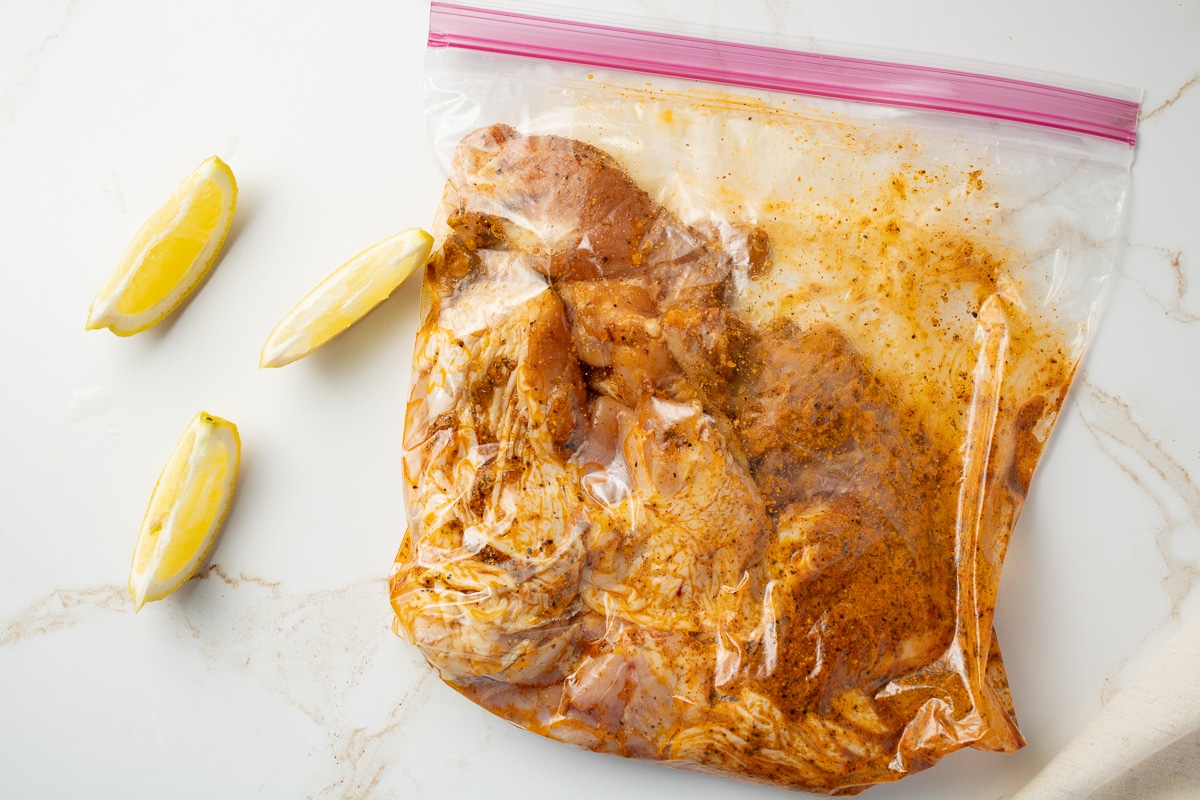 Chicken in a bag mixed with seasonings.