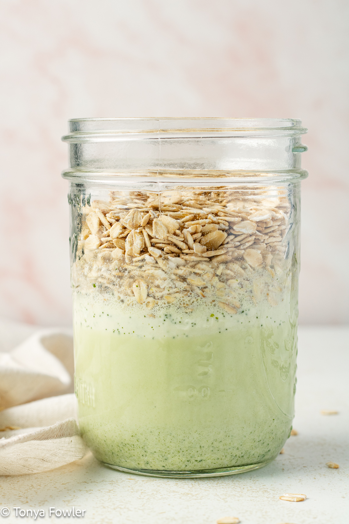 Milk in a jar with rolled oats.