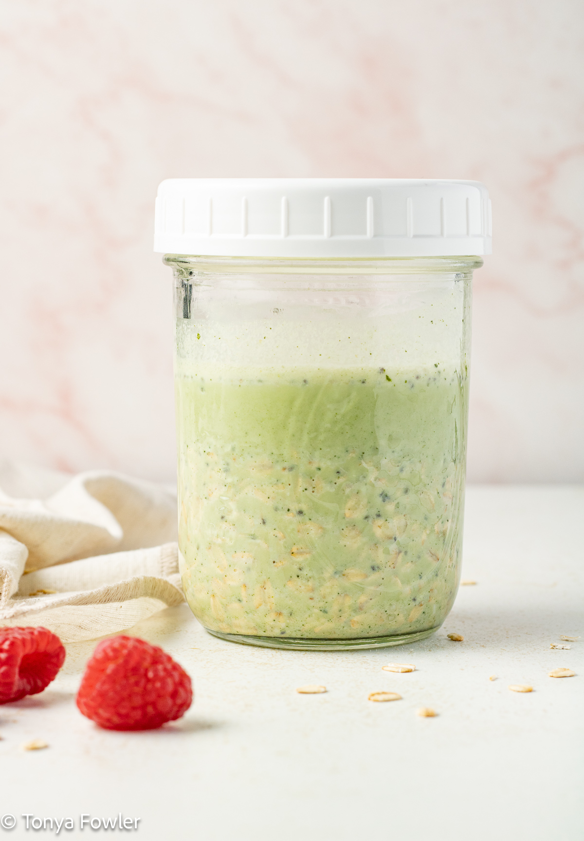 Side view of overnight oats in a jar.