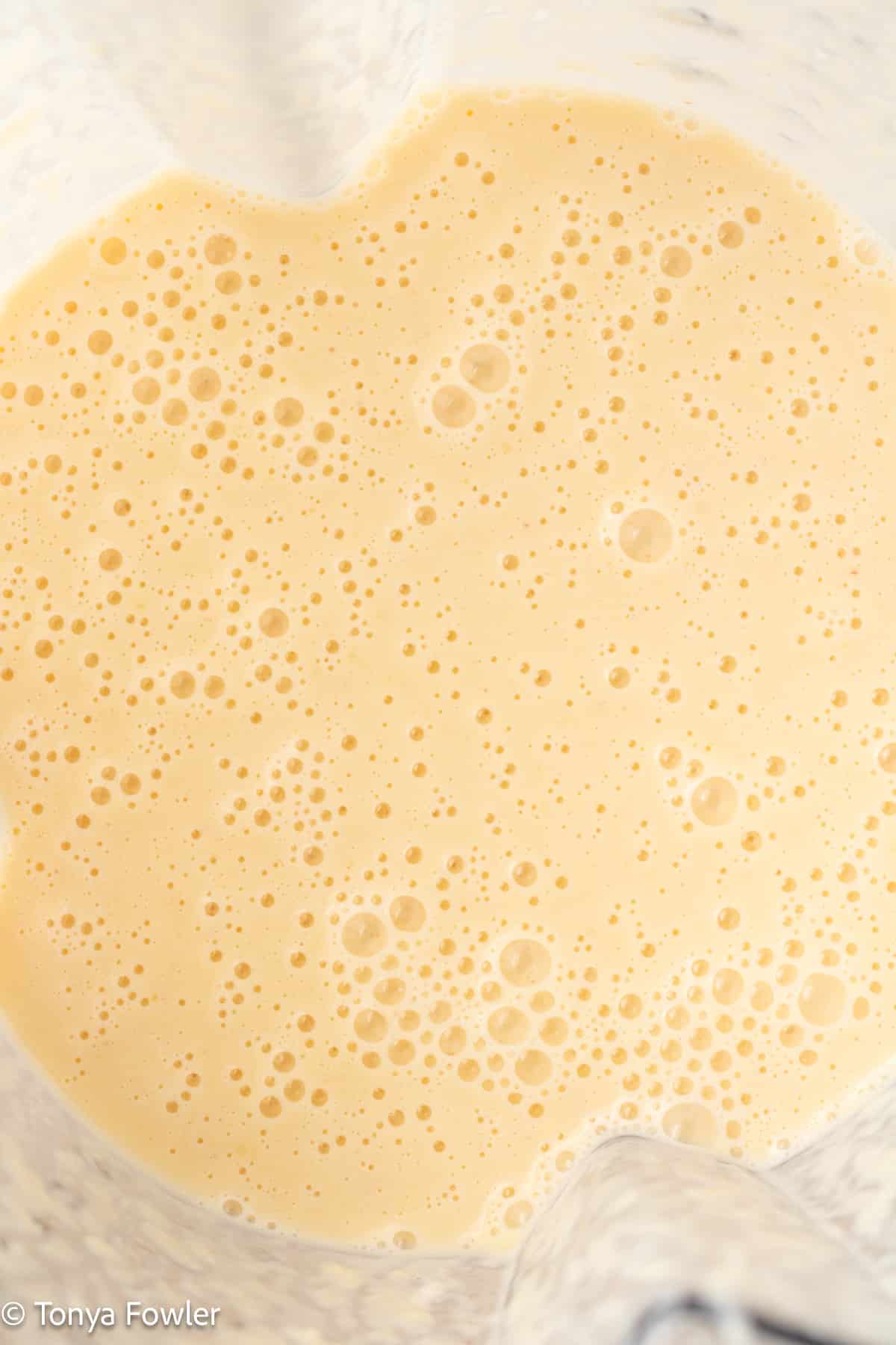 Blended peach yogurt in a blender.