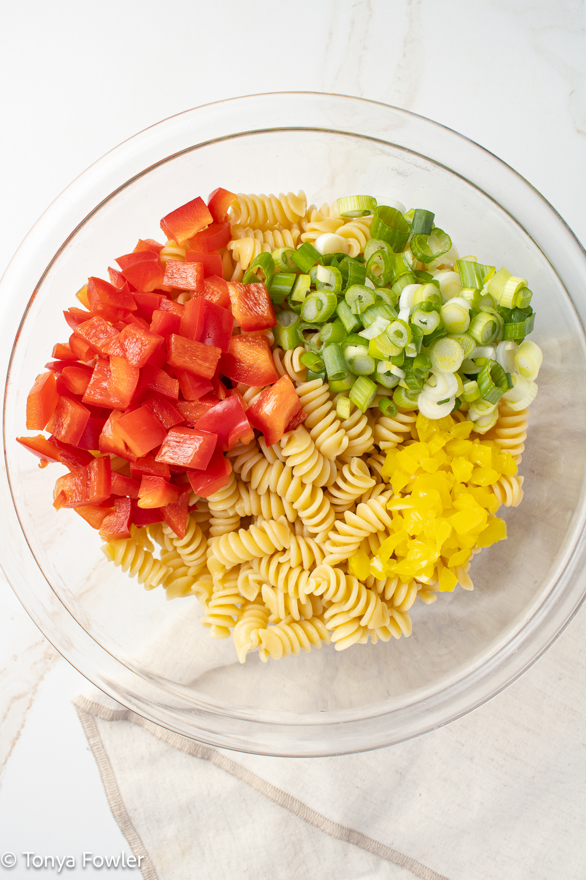Ingredients for pasta salad in a bowl.