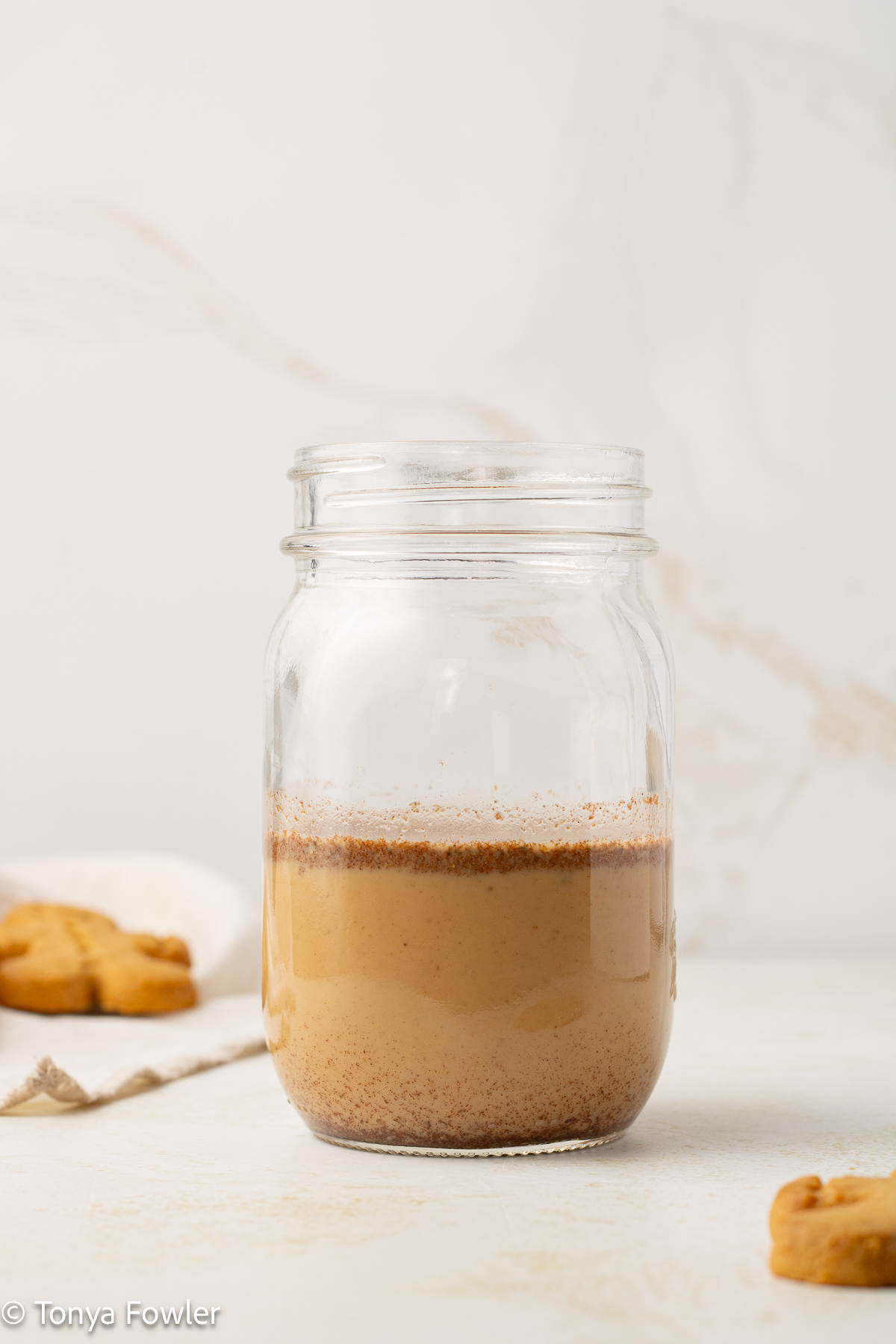 Straight on view of milk and spices in a mason jar.