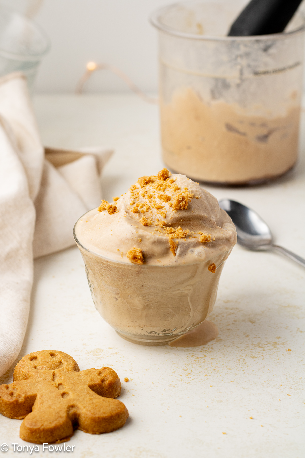 Gingerbread ice cream in a cup topped with gingerbread cookies.